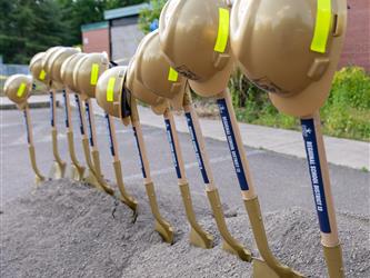 Shovels and hard hats lined up