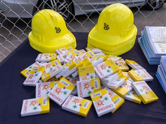 Crayons and plastic hard hats on a table