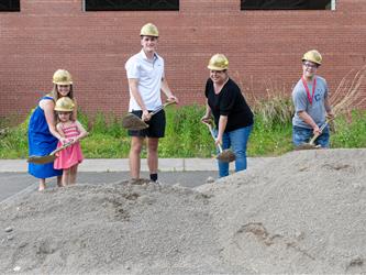 Youngest and oldest student shoveling